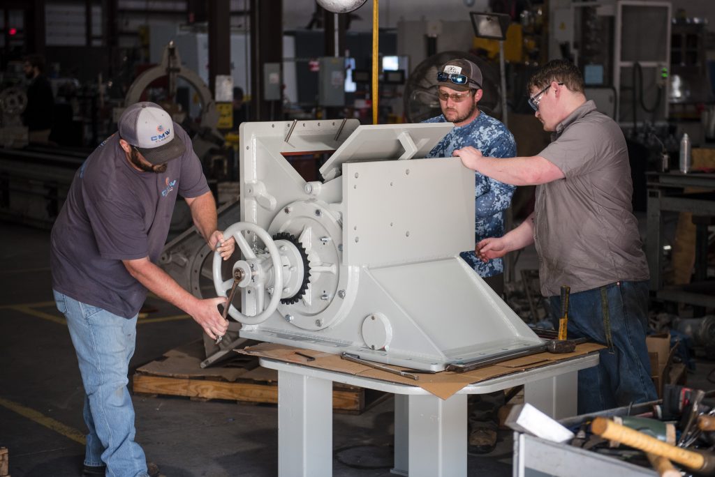 team-assembling-a-mechanical-piece-mechanical-assembly